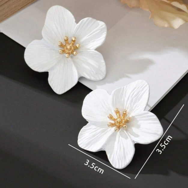 White floral earrings with gold centers 